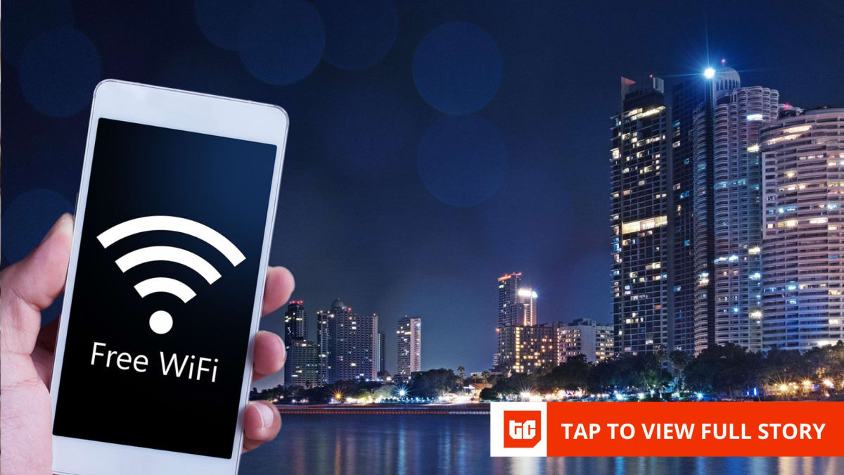 People using smartphones and laptops connected to public WiFi in busy Nigerian city center