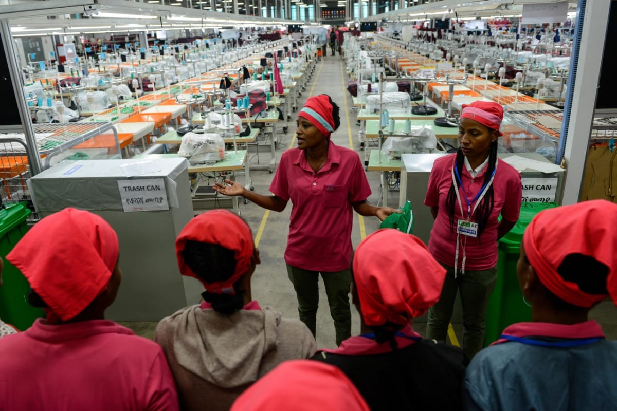 African workers in manufacturing facility representing job creation and economic opportunity across continent
