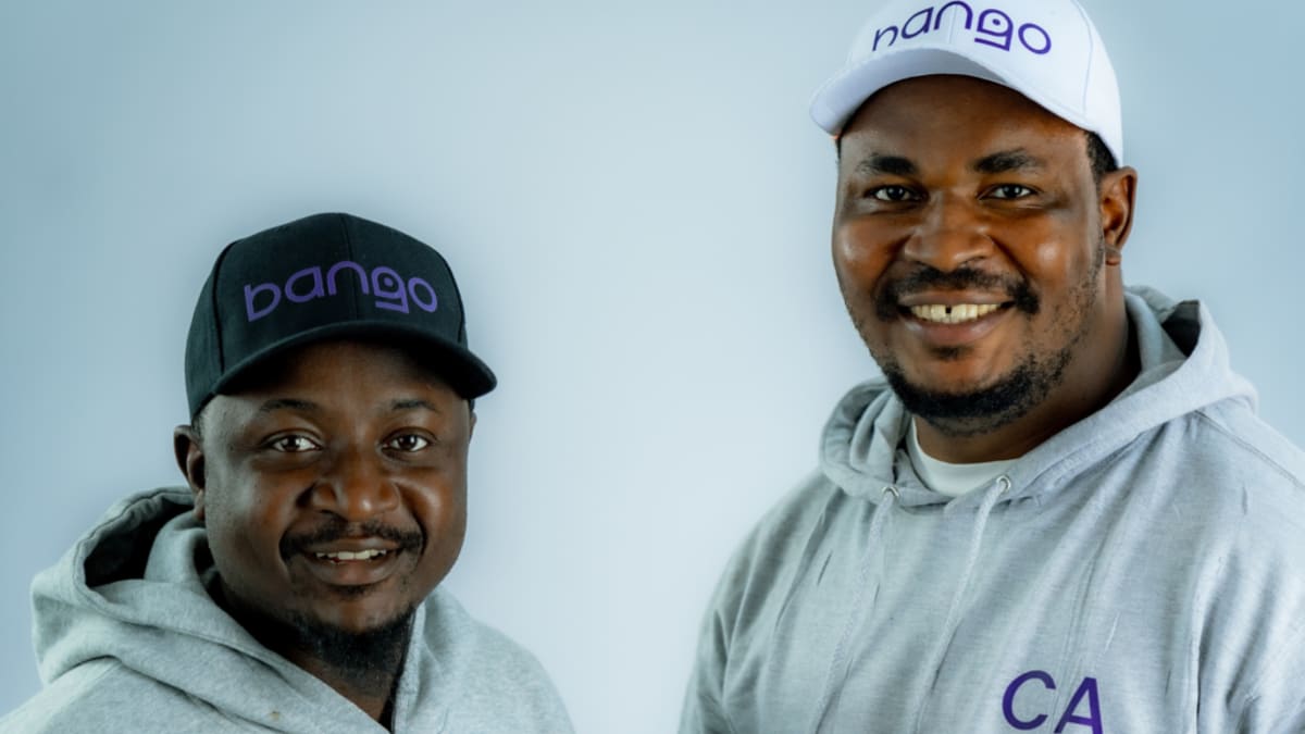 Person using smartphone to check food prices on Bango app in Nigerian market