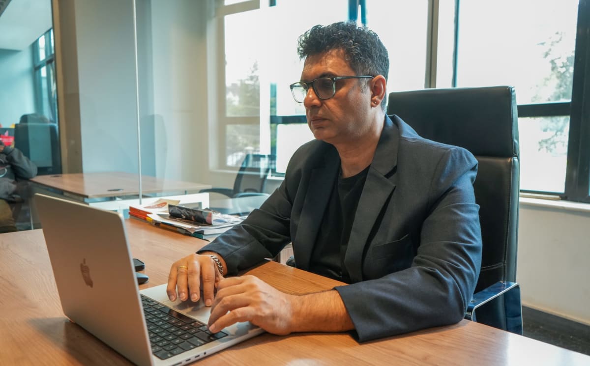 Manish Sardana with Craydel co-founders in modern office with glass walls in Nairobi
