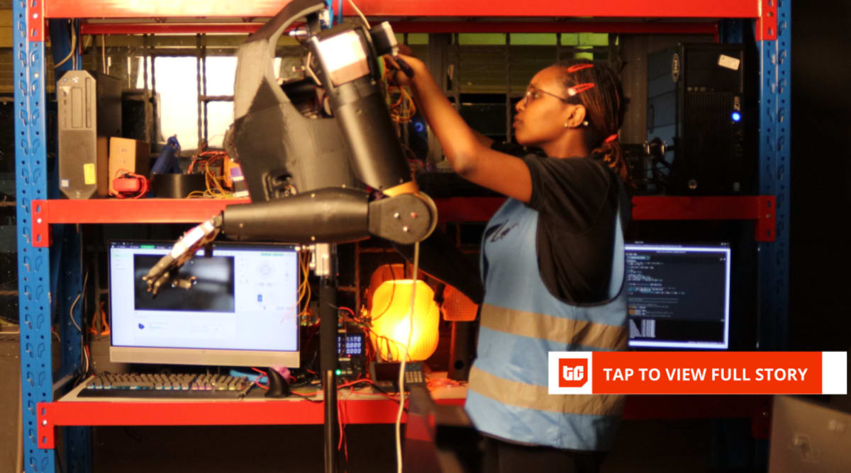 Young Kenyan engineer Norah Kimathi standing with her humanoid sign language robot made from recycled plastic