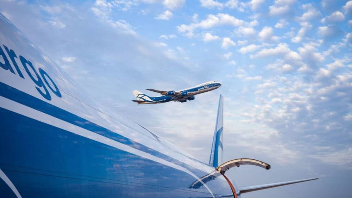 White BETA ALIA CX300 electric cargo aircraft on airport tarmac preparing for flight