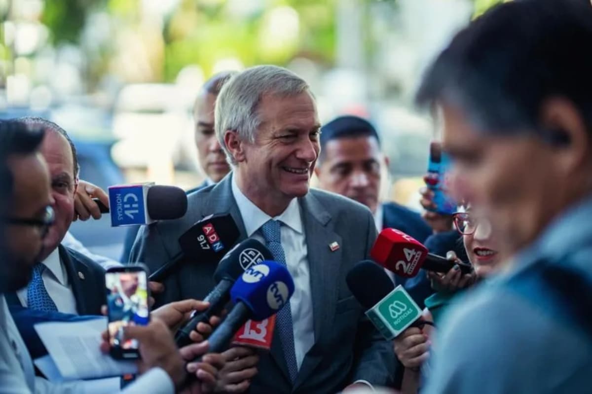 ** Solar panels and wind turbines in Chilean desert landscape with battery storage facility