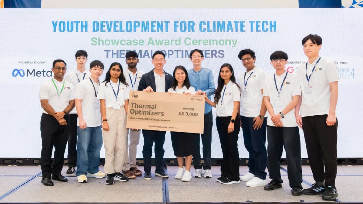 Students and officials pose with climate technology prototypes at Singapore youth summit