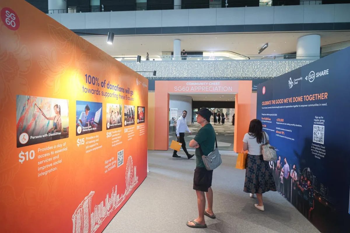 Crowd celebrates charitable giving milestone at Punggol Coast Mall during Singapore's SG60 independence celebration