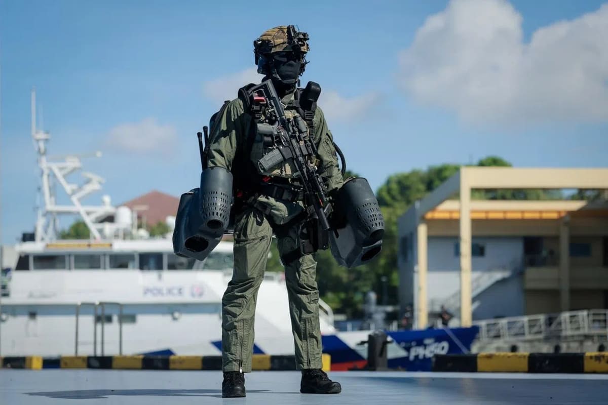 Singapore police officer wearing jet-propelled suit during demonstration at coast guard base