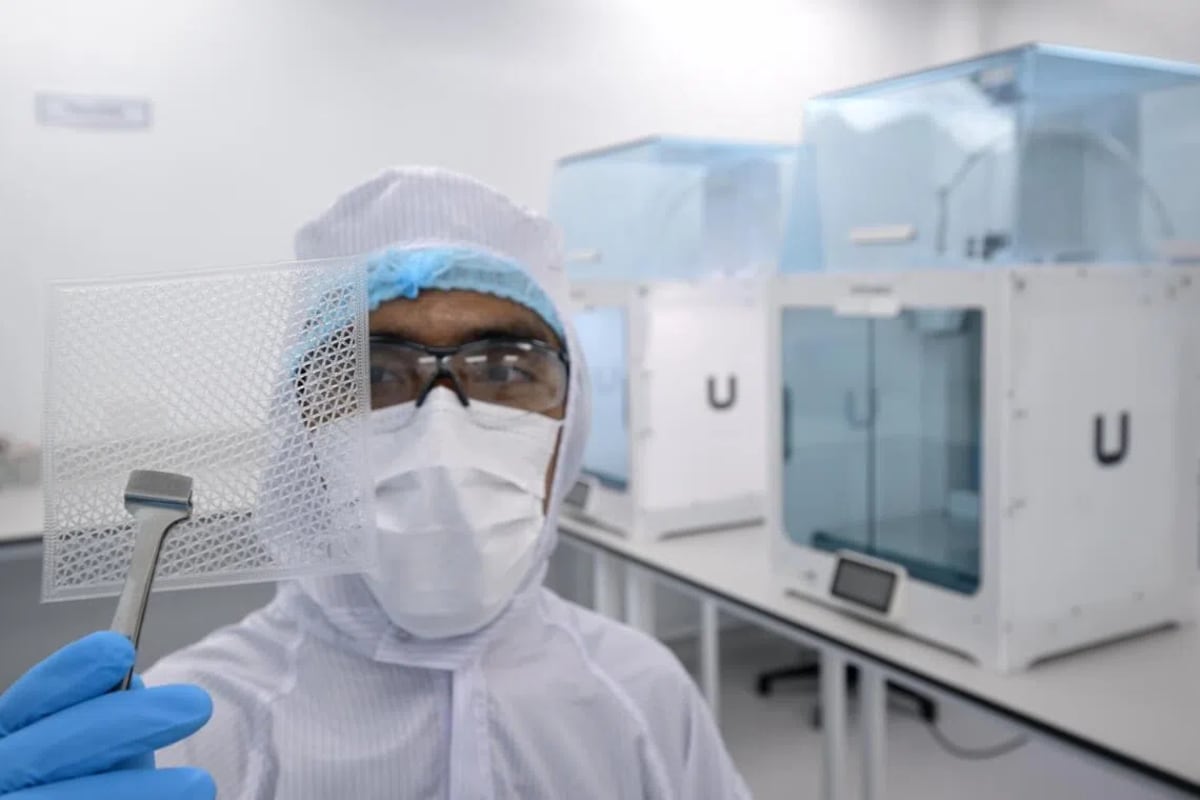 Research engineer holding translucent synthetic skin material designed for treating severe burns