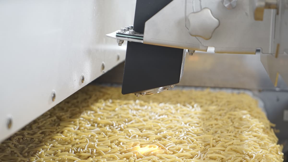 Modern industrial pasta production line with quality monitoring technology in food processing facility