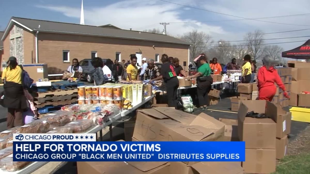 Volunteers unloading supplies from truck to help tornado victims at church parking lot