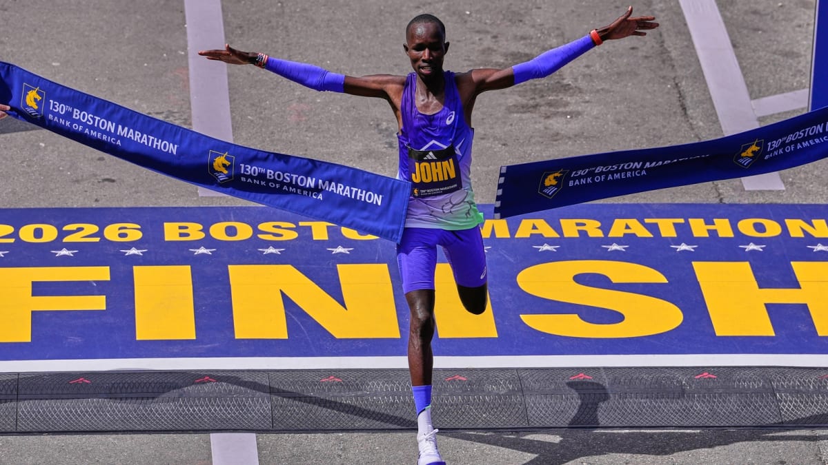 John Korir of Kenya celebrates with outstretched arms crossing Boston Marathon finish line