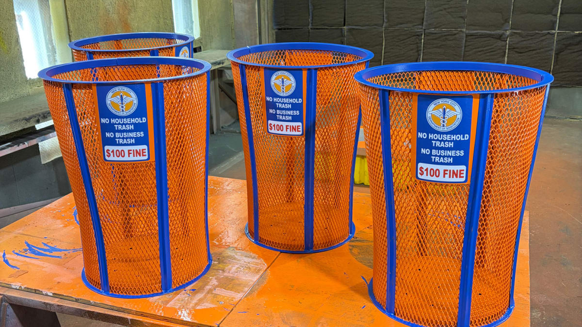 Blue and orange New York Knicks commemorative trash bin on city street during championship celebration