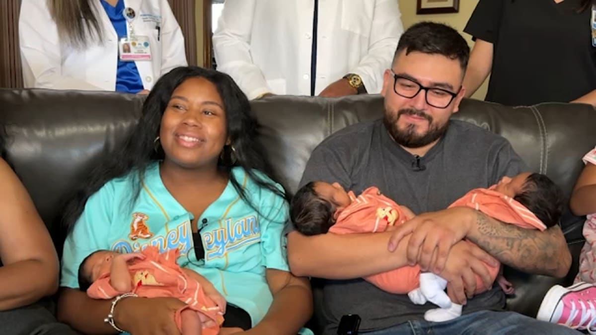 Three newborn baby boys lying together, naturally conceived triplets from South Bay California