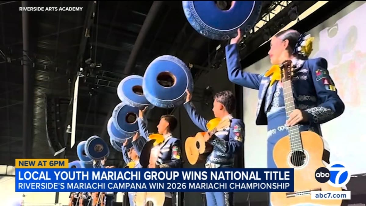 Young mariachi musicians in traditional attire performing with instruments at national championship competition