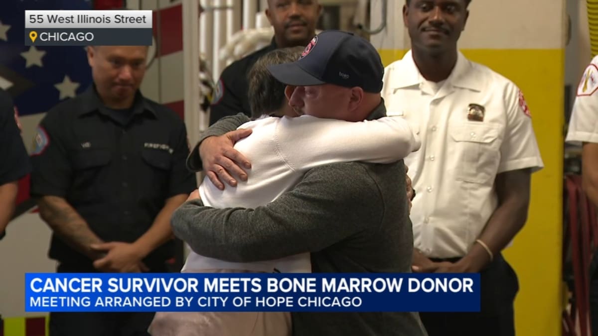 Cancer survivor Crystal Cornelius embracing firefighter Cody Duge who donated bone marrow to save her life