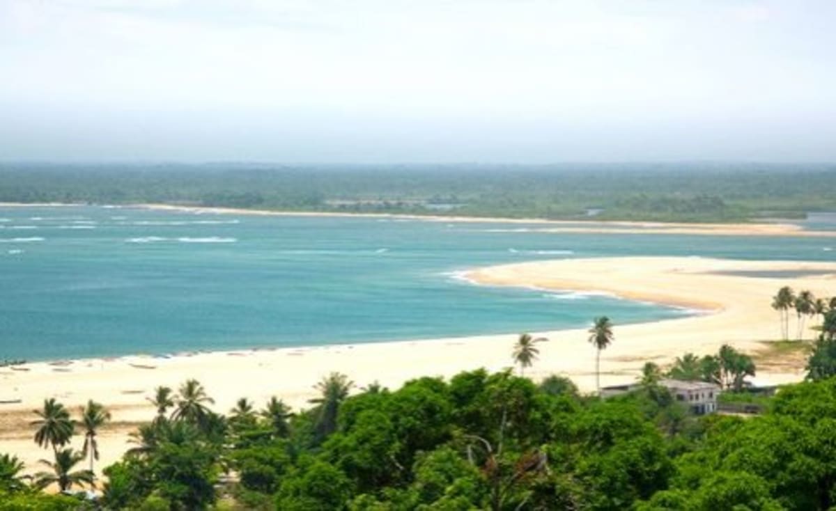 Liberian fishing boats on Atlantic Ocean coastline with nets and equipment