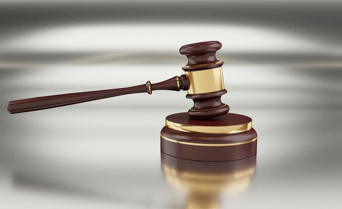 Modern courthouse exterior in Botswana with people entering for justice proceedings