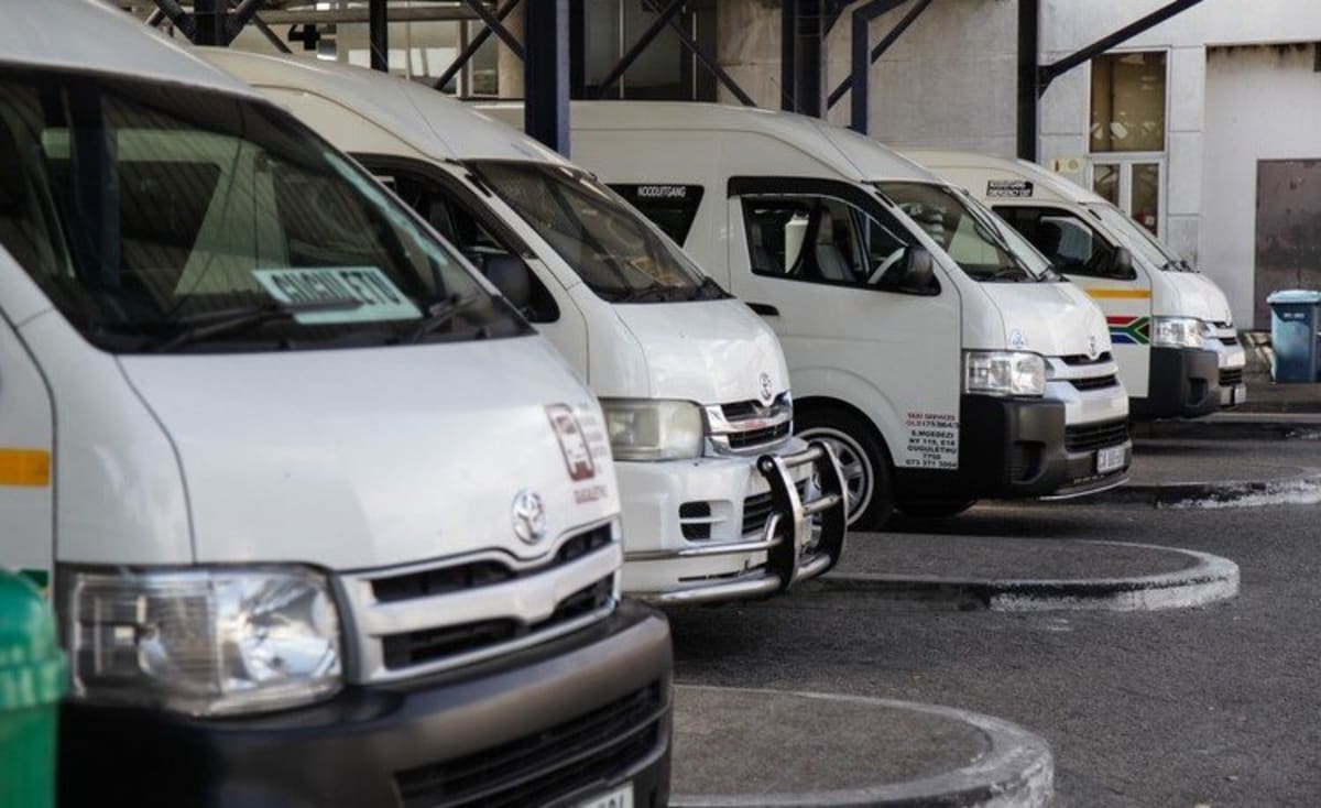 Minibus taxis lined up at busy Gauteng transportation hub serving daily commuters