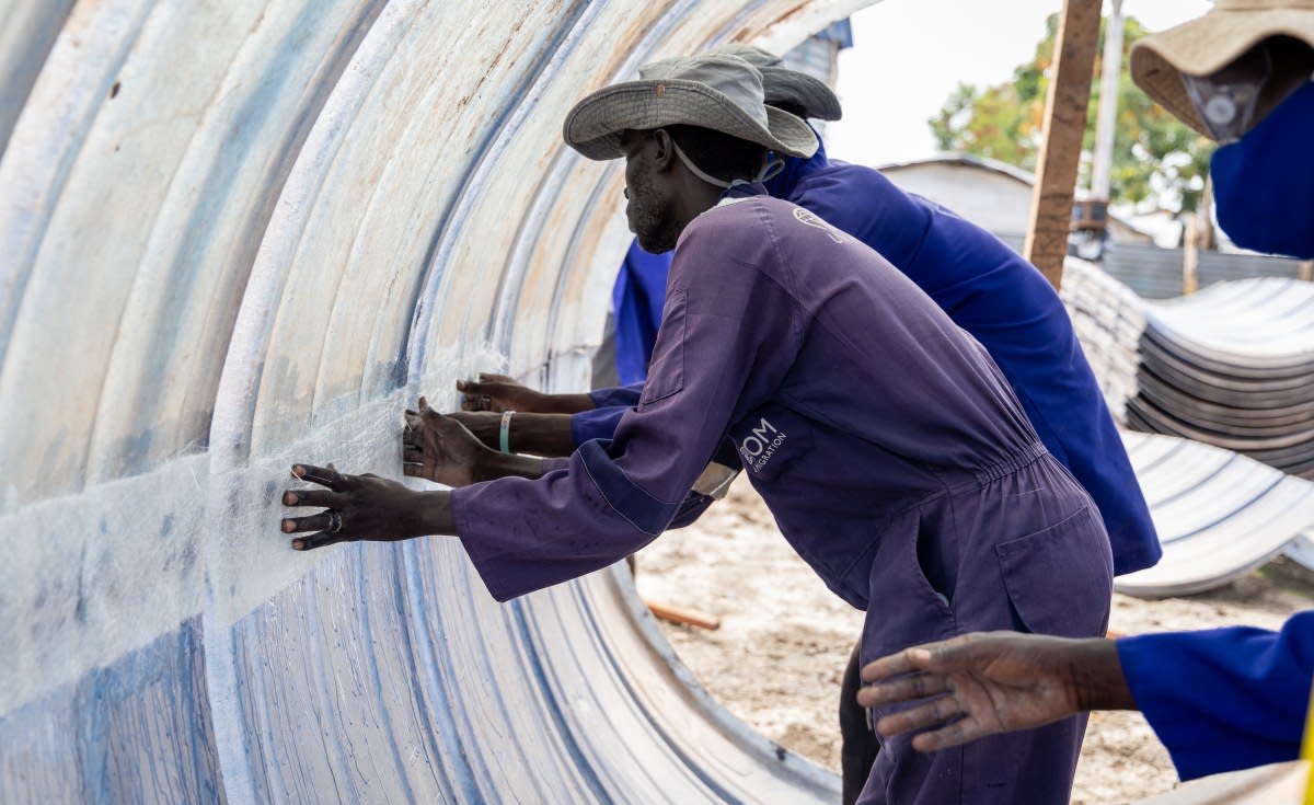 African farmer with solar panels and fresh produce in Kenya agricultural community