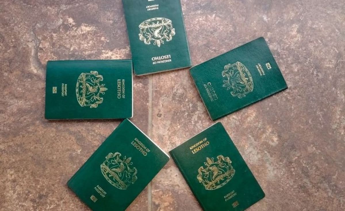 Border crossing gate between South Africa and Lesotho with travelers walking through checkpoint