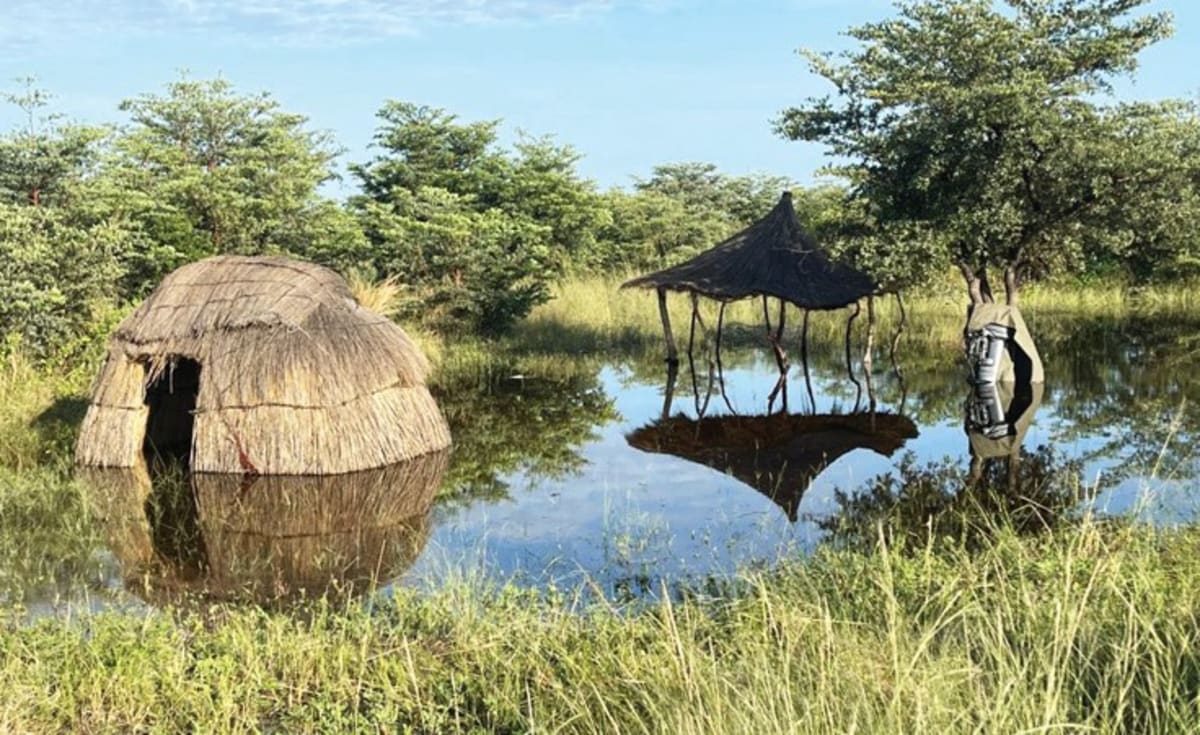 Aerial view of flooded villages in Namibia's Zambezi region with submerged buildings and relief supplies