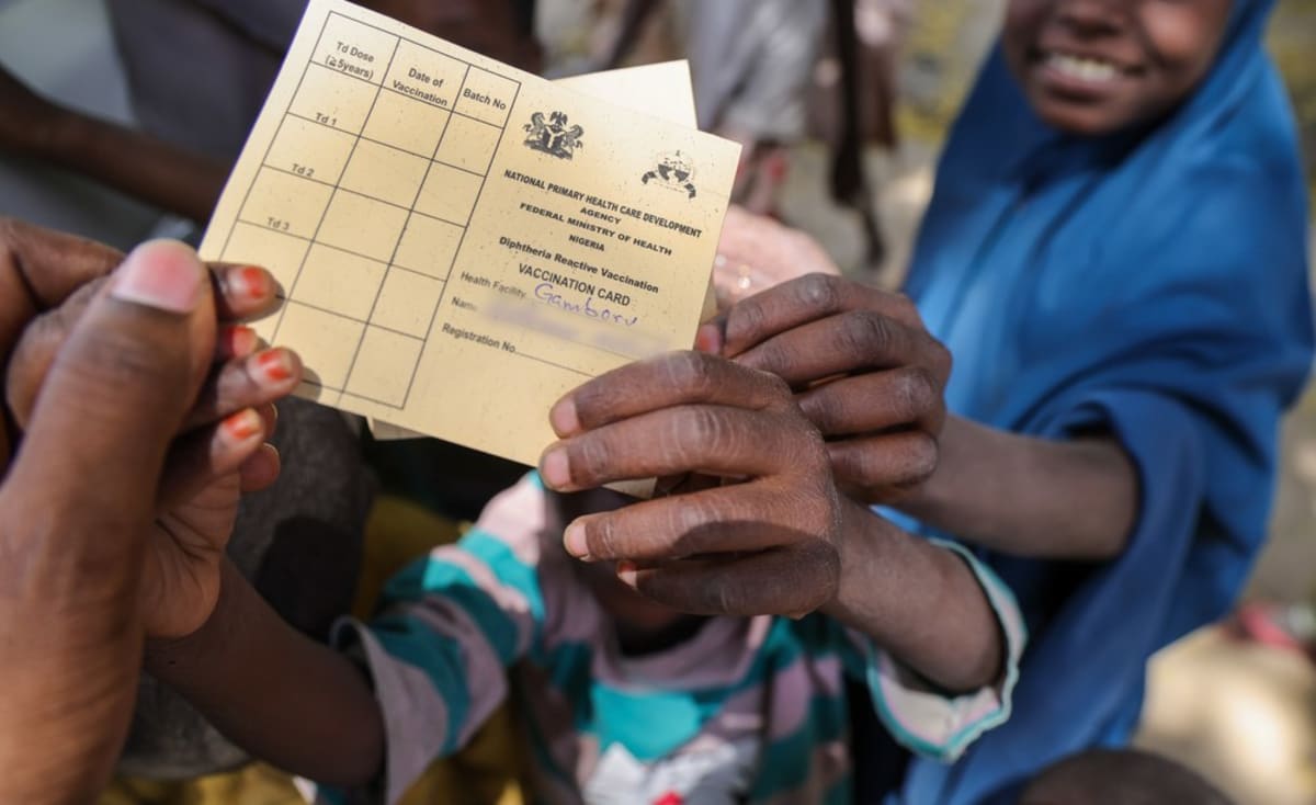 Nigerian health workers administering vaccines to children during diphtheria prevention campaign in Maiduguri