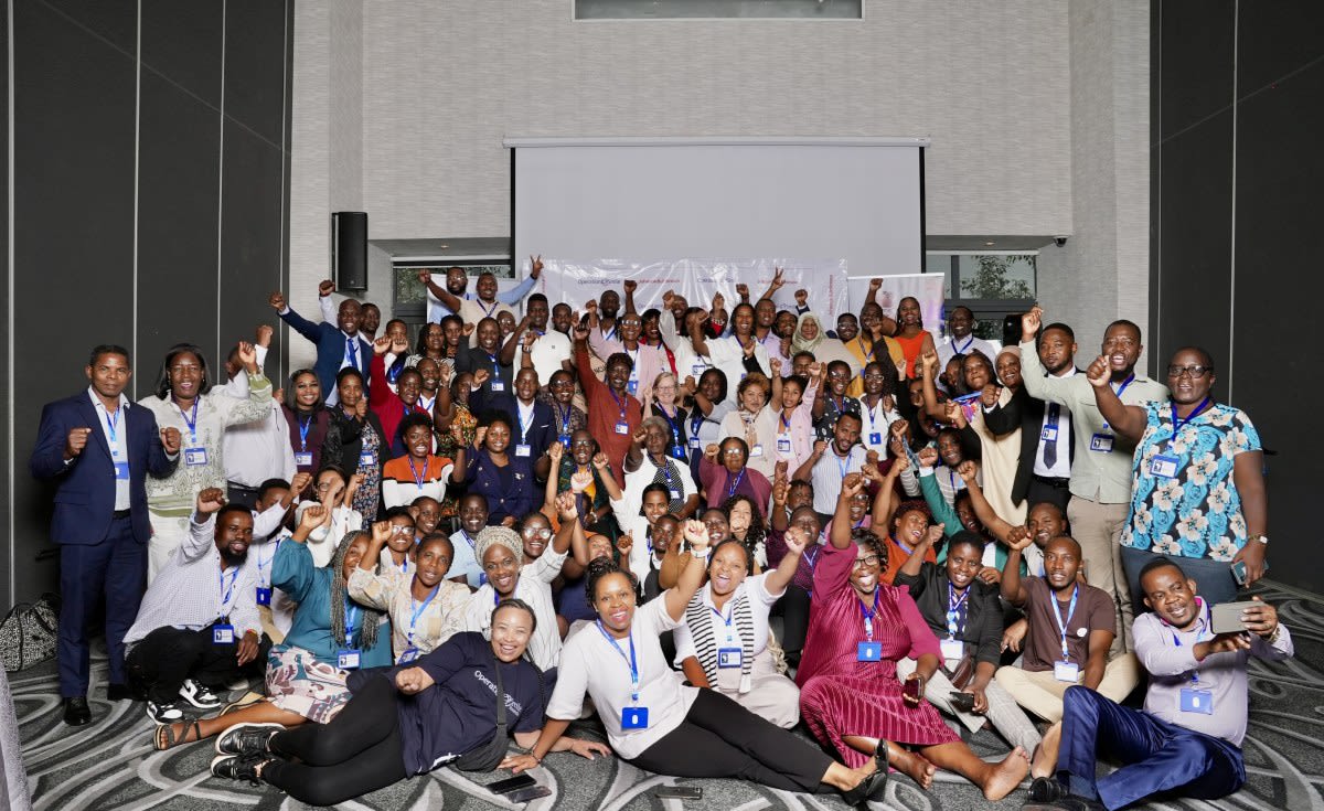 Group of African nurses in medical scrubs participating in hands-on clinical training session together