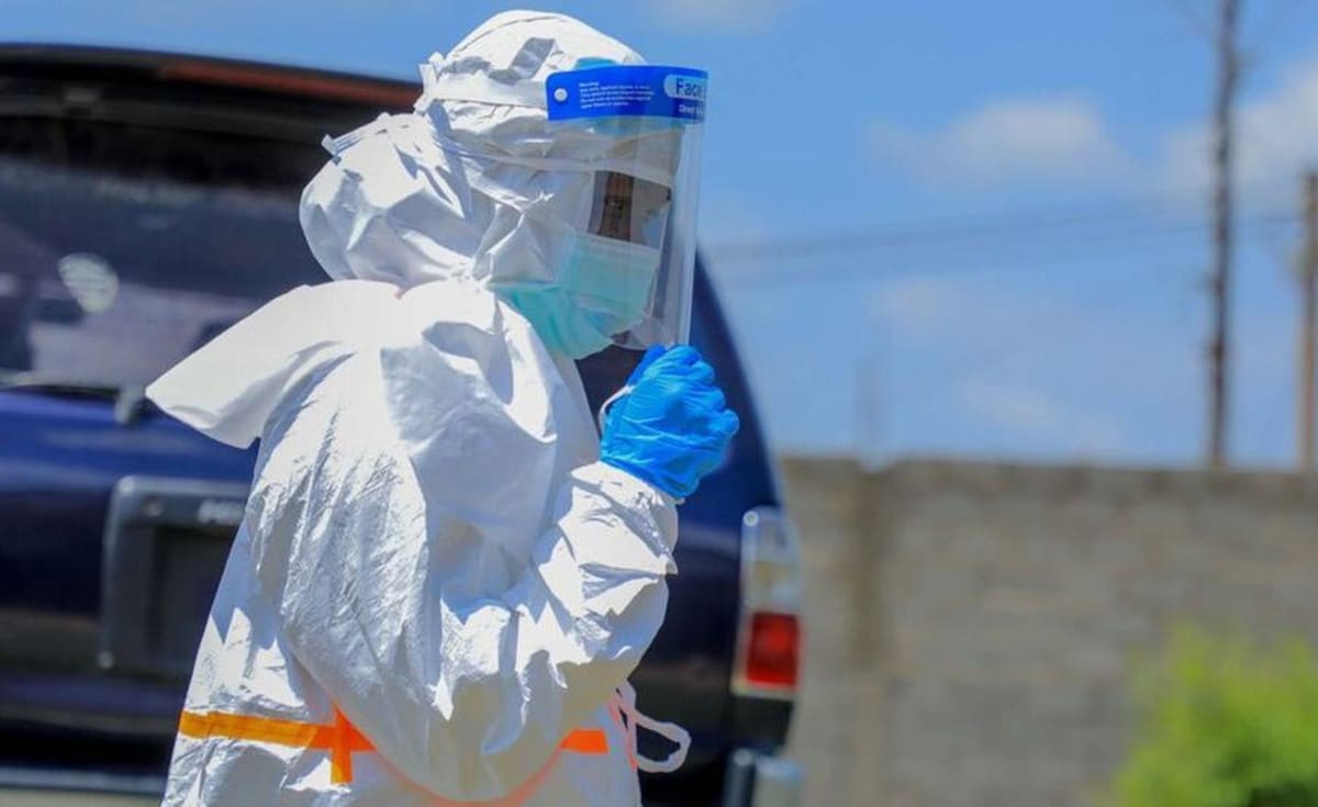 African health workers in protective equipment coordinate emergency response efforts at medical facility