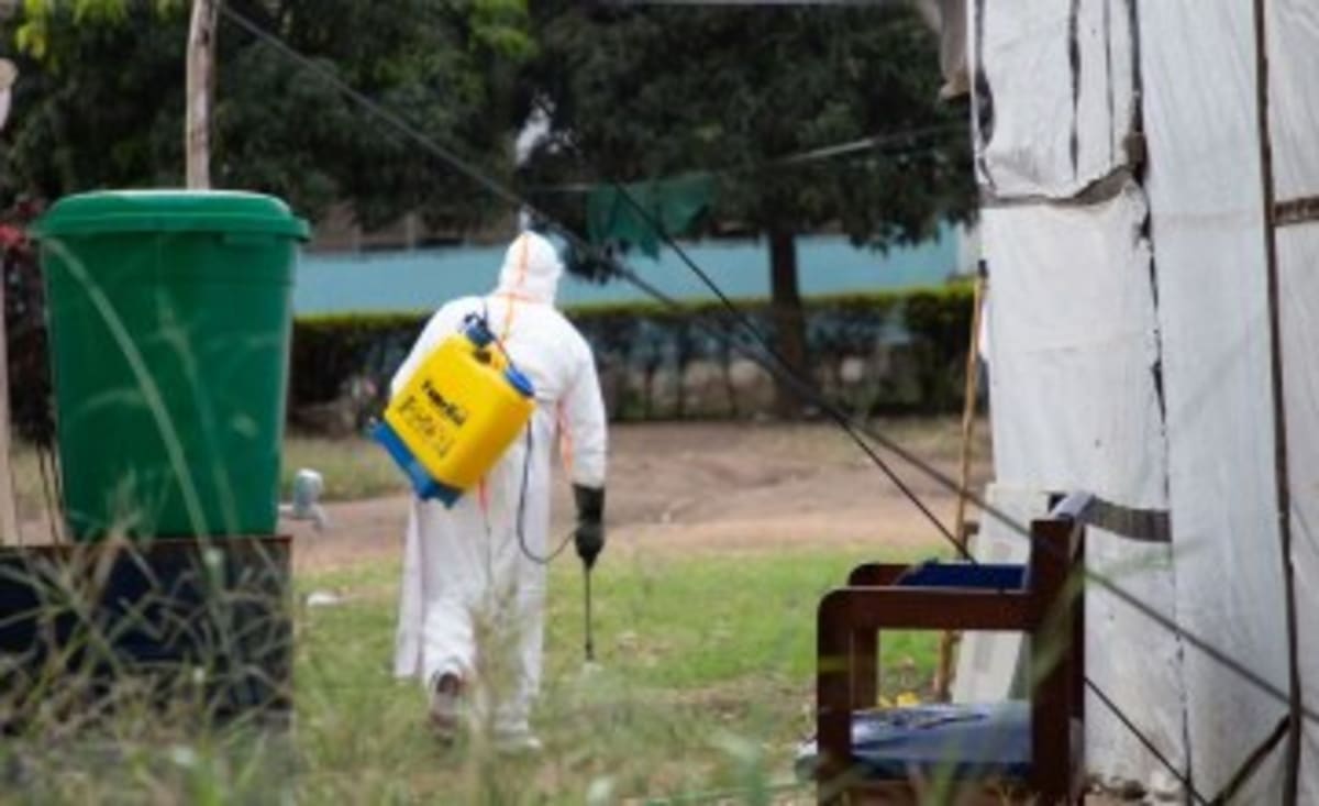Healthcare workers in protective gear preparing Ebola vaccines for administration in Democratic Republic of Congo