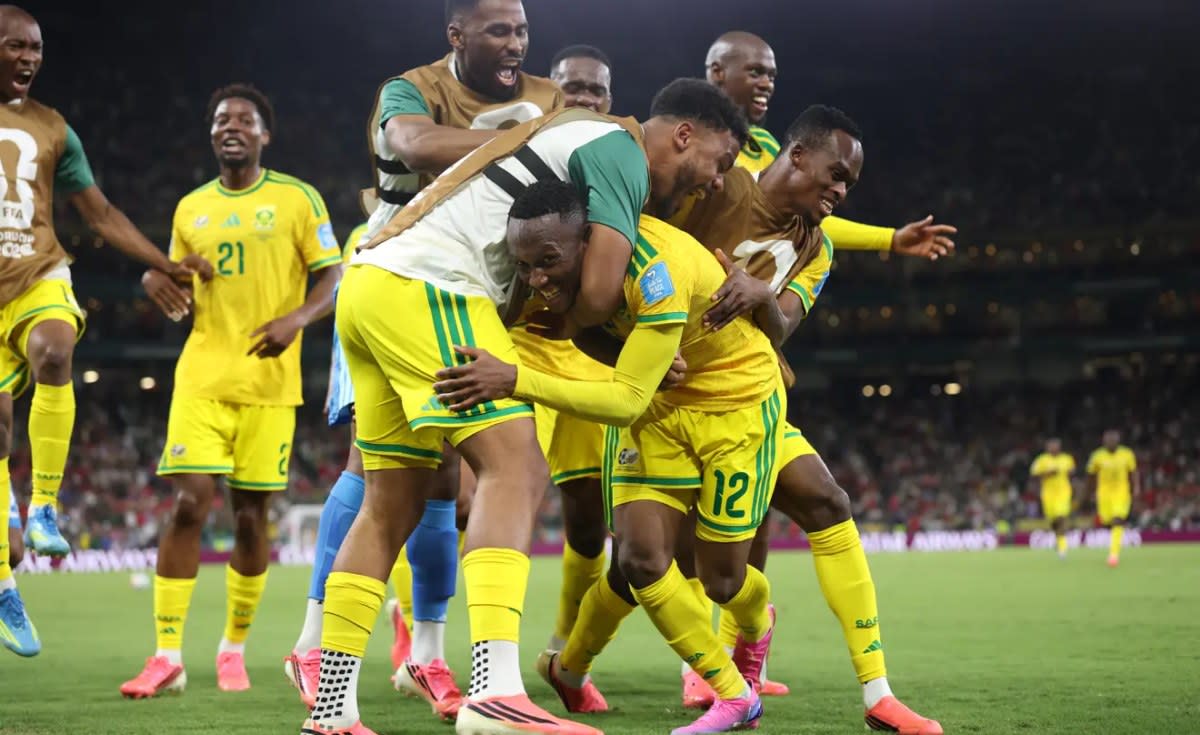 South African soccer players celebrate on field after historic World Cup qualification victory