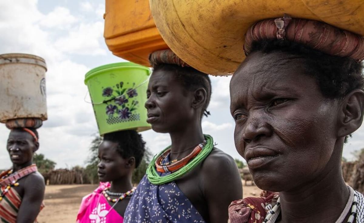 South Sudanese families receiving humanitarian assistance and drought preparation information in Eastern Equatoria state