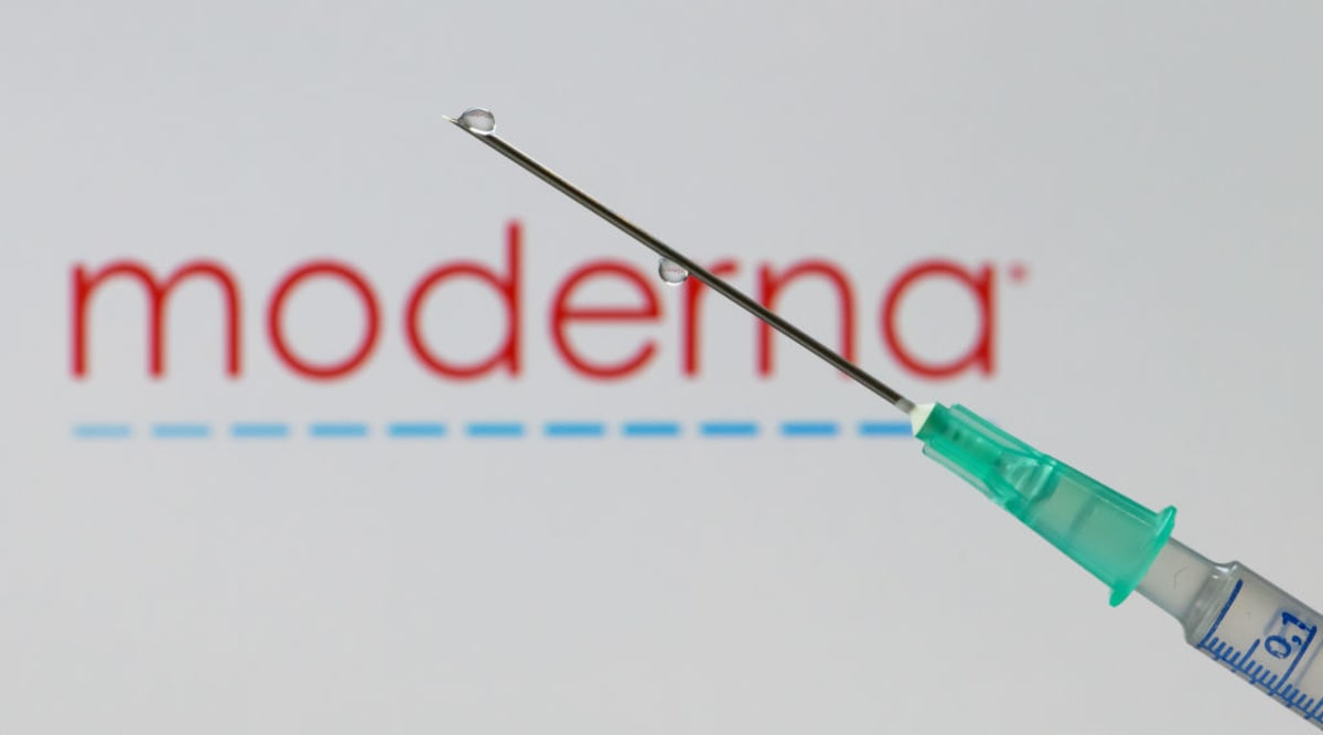 Scientists working with vaccine vials in modern laboratory research facility setting