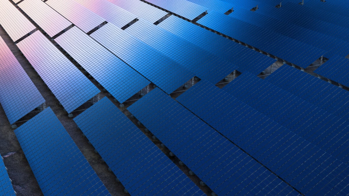 Solar panels and wind turbines generating clean renewable energy under bright blue sky