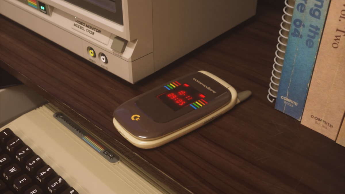 Beige Commodore Callback 8020 flip phone with retro calculator-style exterior display open on table