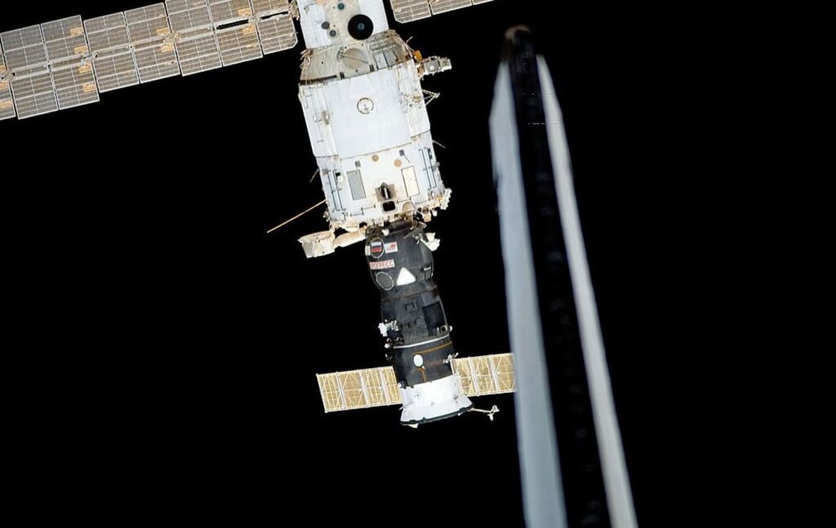 International Space Station orbiting Earth with solar panels extended against black space backdrop