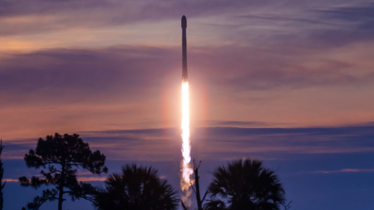 Weathered SpaceX Falcon 9 rocket booster landing on ocean drone ship after launch