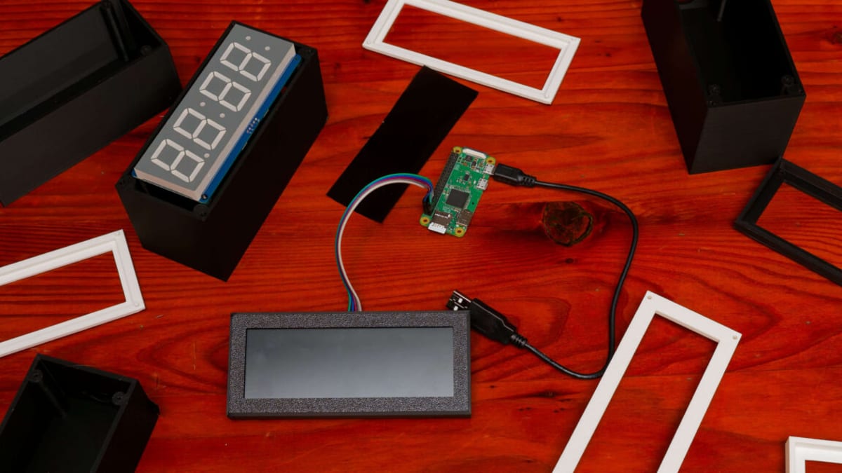 Red LED digital clock with seven-segment display showing time in custom 3D-printed black case
