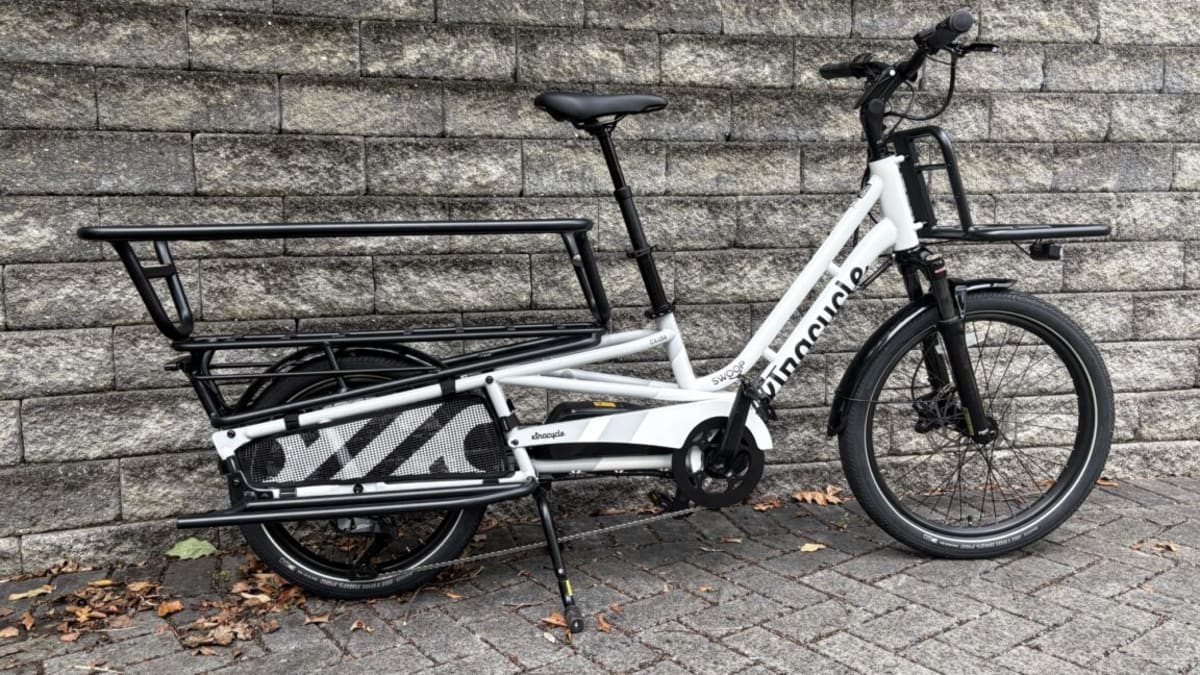 Silver cargo e-bike with extended rear rack and smaller back wheel for carrying passengers or groceries