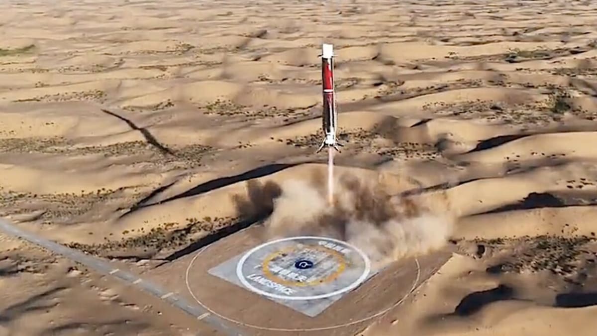 Stainless steel Zhuque-3 rocket landing vertically on four legs in Chinese desert