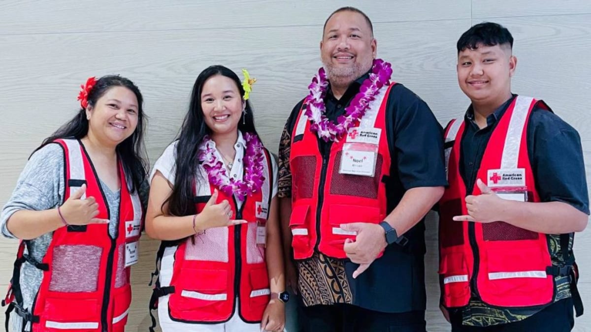 Four-person Alarcon family smiling together in Red Cross volunteer shirts in Hawaii