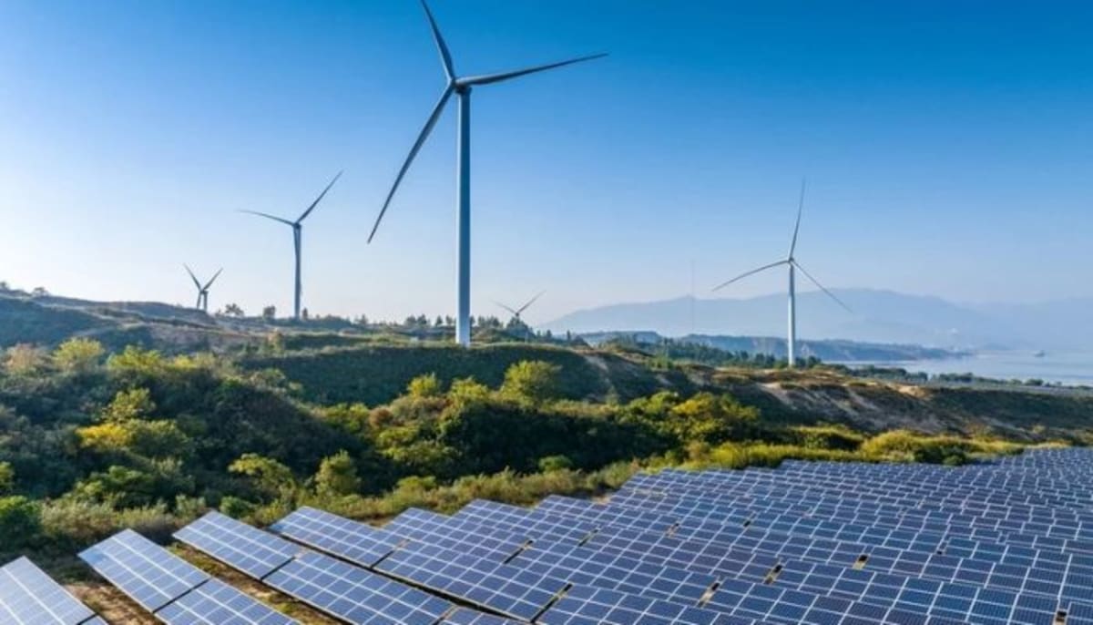 Solar panels and wind turbines representing global clean energy investment growth