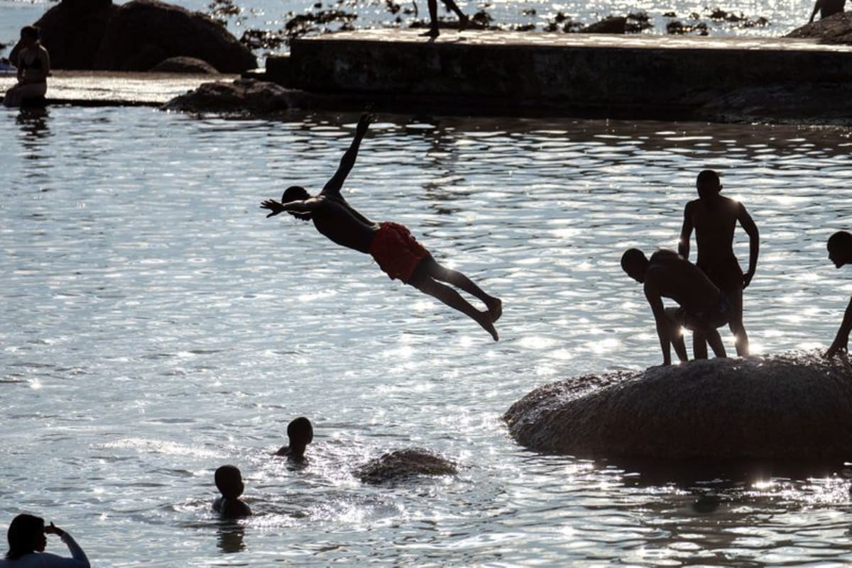 Man diving into Camps Bay tidal pool during Cape Town's 40-degree heatwave