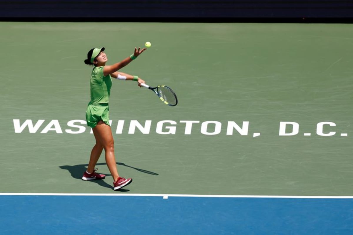 Alexandra Eala holding Washington Open trophy surrounded by cheering Filipino fans celebrating historic win