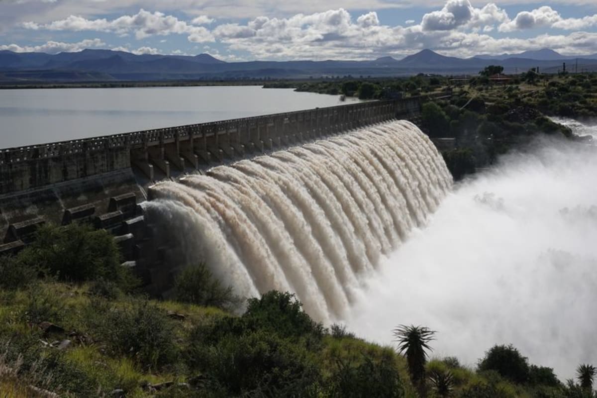** Swollen Kammanassie River flowing powerfully under damaged bridge in Uniondale, South Africa after historic rainfall