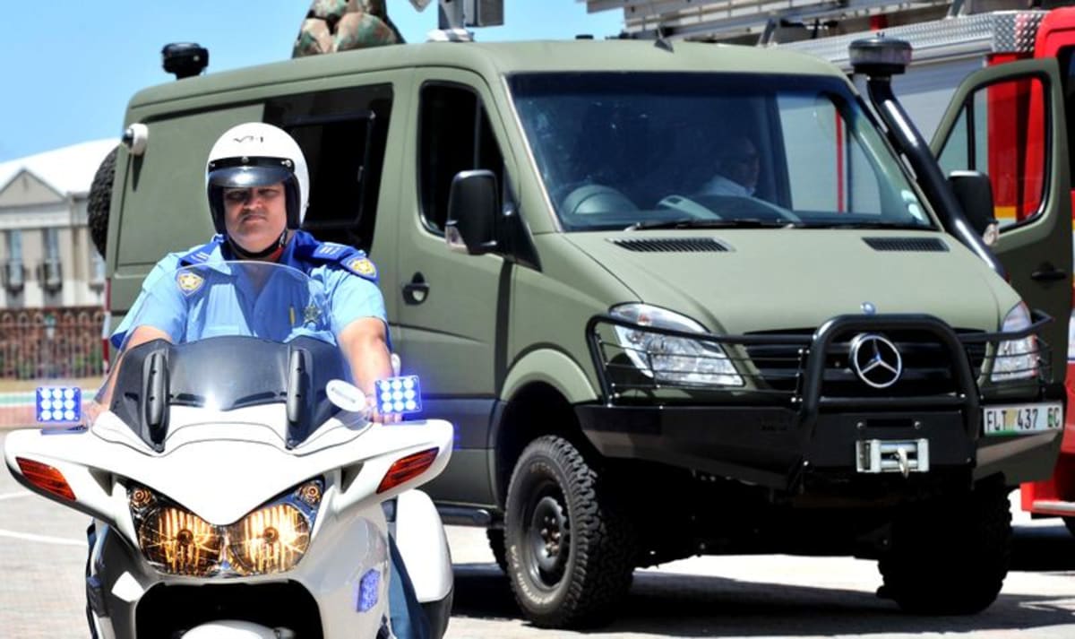 White mobile surveillance vehicle with mounted camera equipment parked at municipal facility