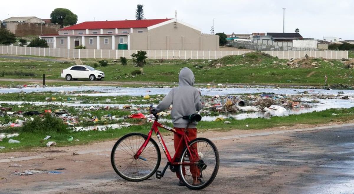 Young boy standing in informal settlement community in South Africa's Western Cape province