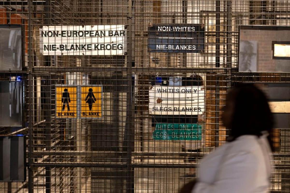 Visitor walks past historical exhibits inside the Apartheid Museum in Johannesburg, South Africa