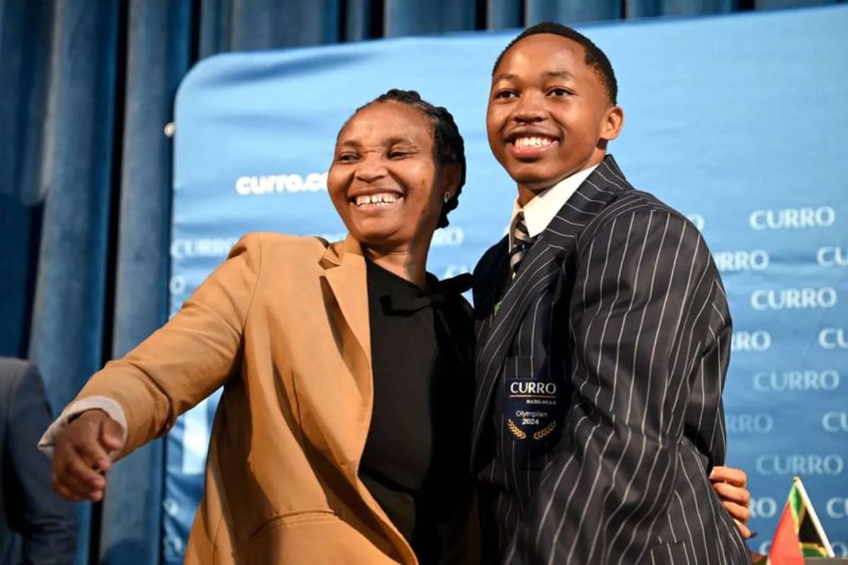 Bayanda Walaza stands with his mother Tholiwe at athletic celebration ceremony