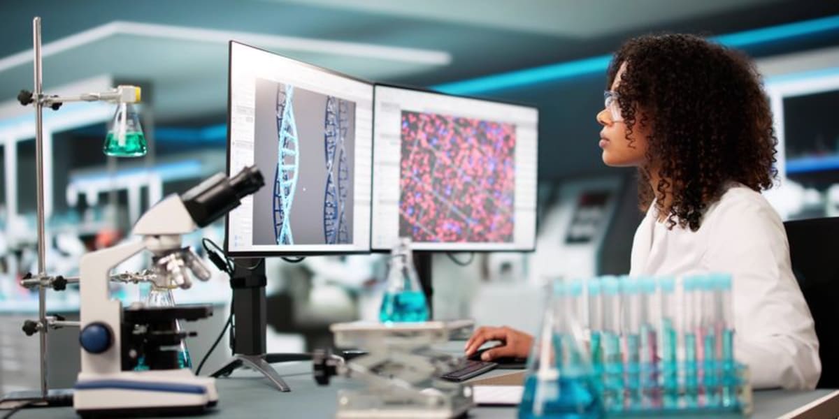 Scientists and business professionals collaborating in modern research laboratory discussing gene therapy development