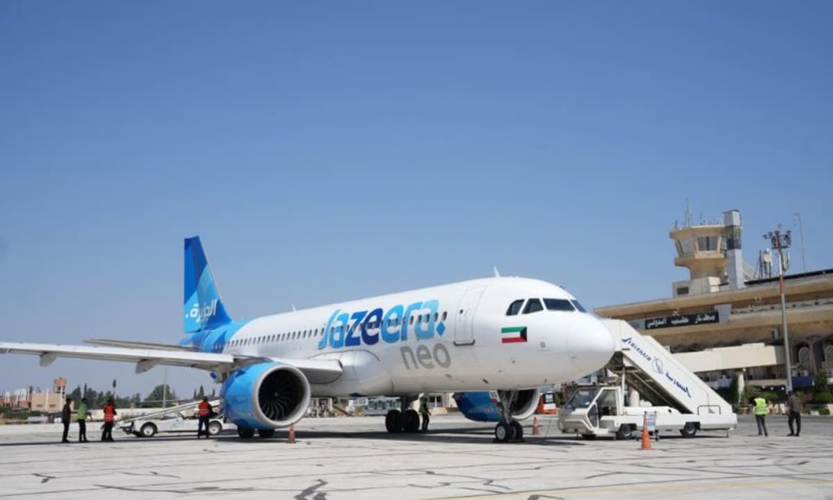 Modern airport terminal exterior under blue sky showing hopeful reconstruction of Syrian aviation infrastructure
