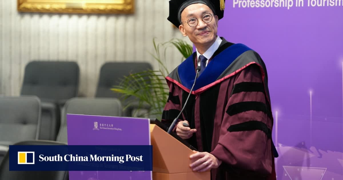 Professor Robert Li stands in academic regalia being congratulated by colleagues at inauguration ceremony